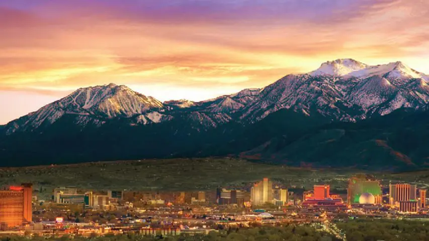 City with mountainous sunset backdrop