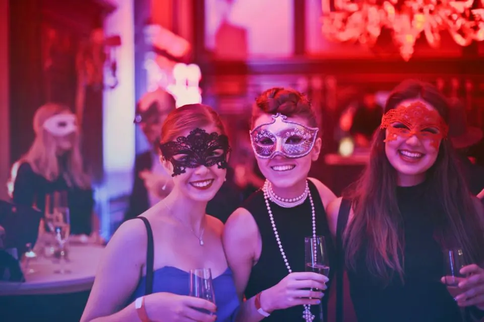 Masquerade party attendees with masks