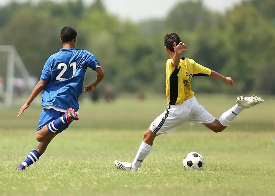 Soccer players on green field