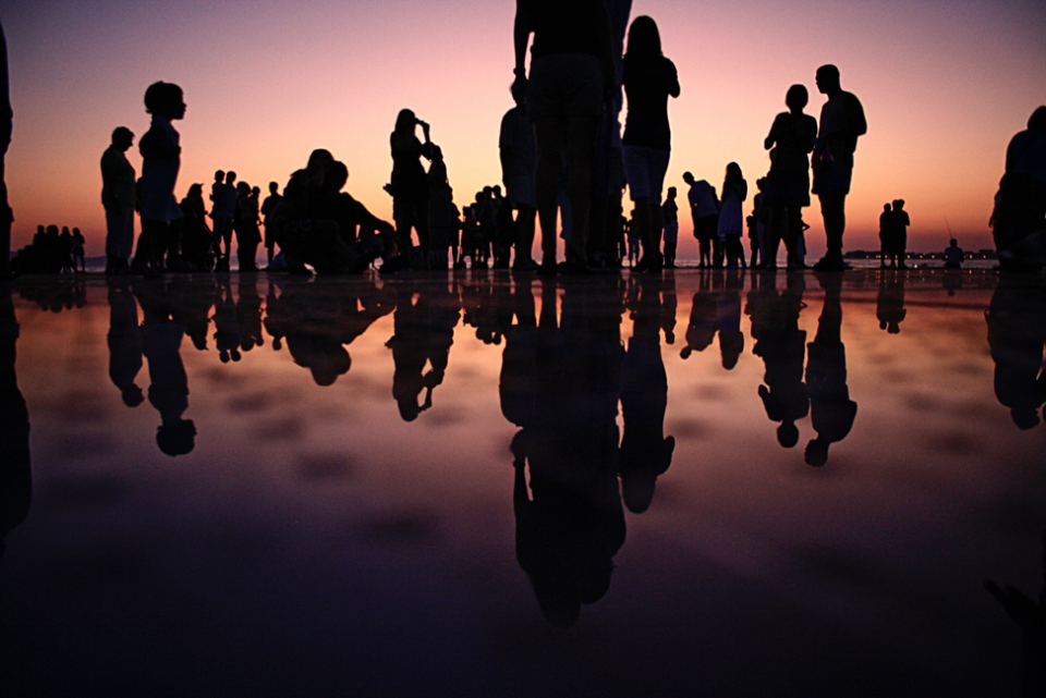 Sunset crowd with reflections