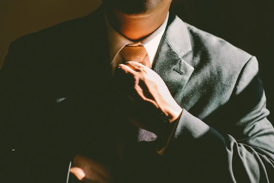 Person adjusting tie professional attire