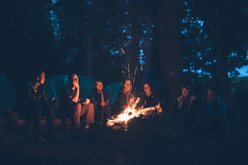 Group camping around a campfire