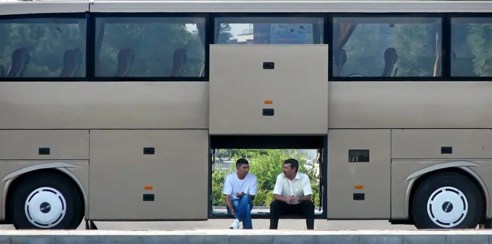 Bus passengers sitting and conversing