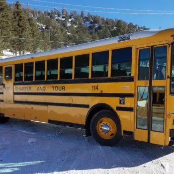 Yellow charter bus in snow