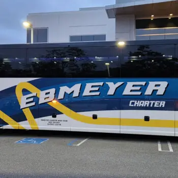 Charter bus parked outside building