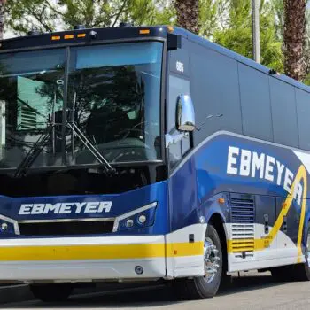 Blue charter bus palm trees