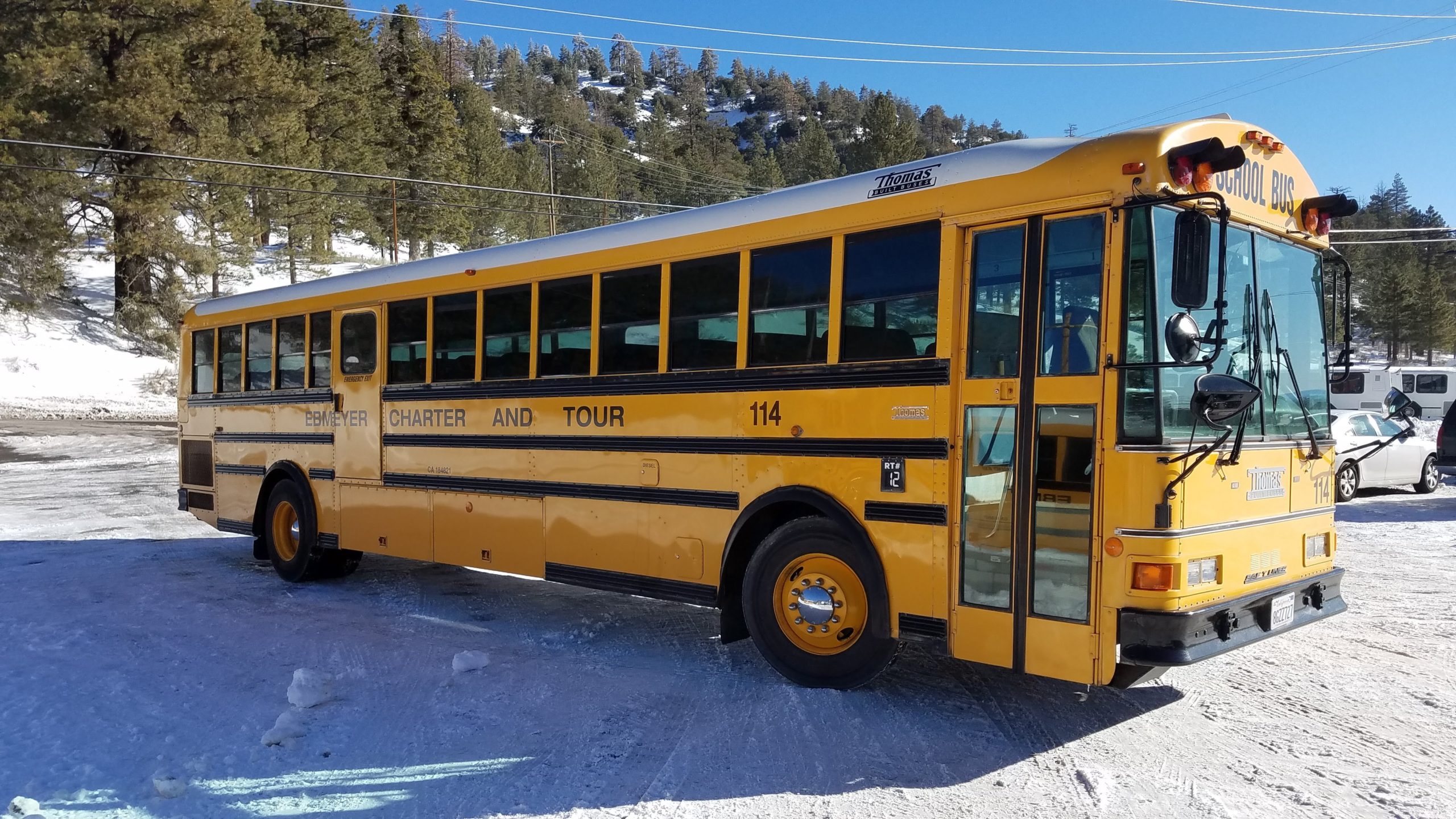 Yellow charter bus in snow