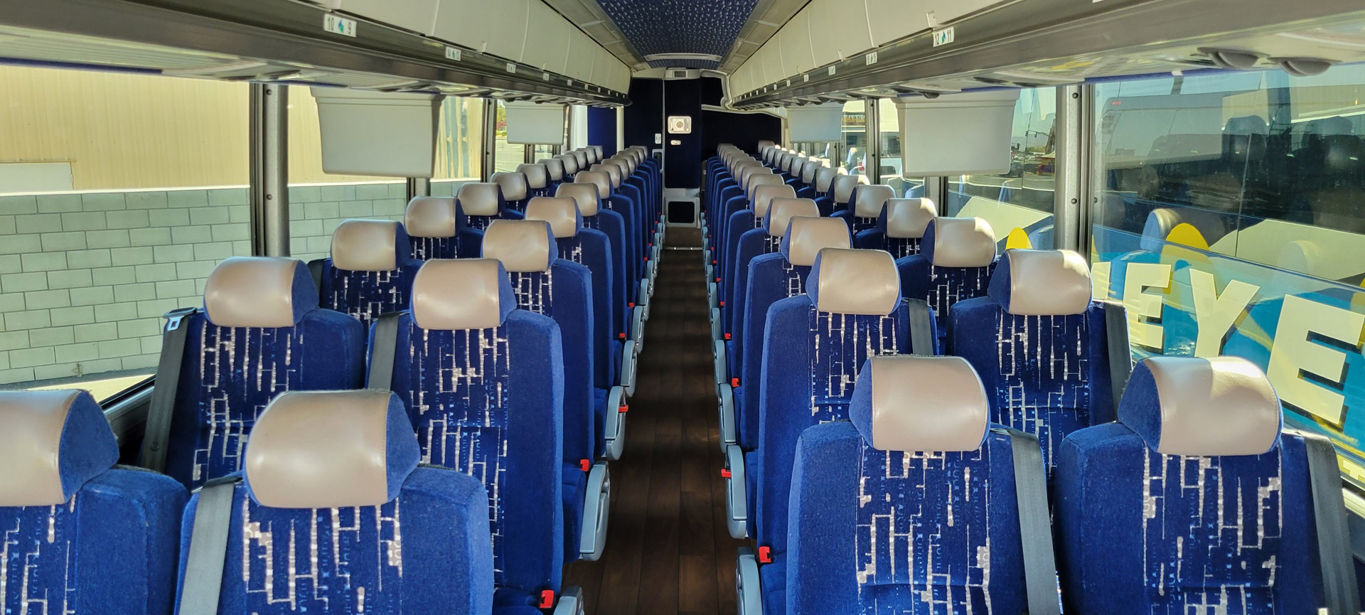 Spacious blue charter bus interior