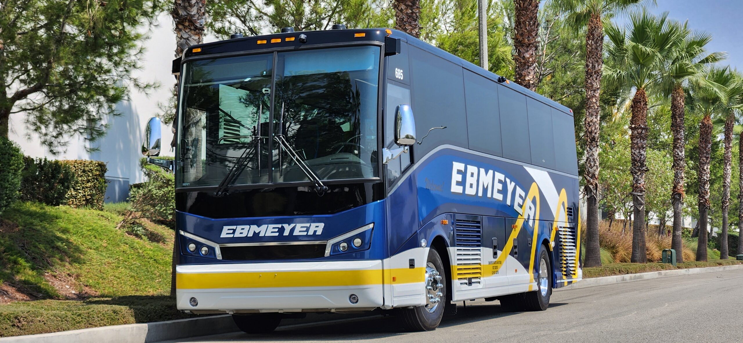 Blue charter bus palm trees