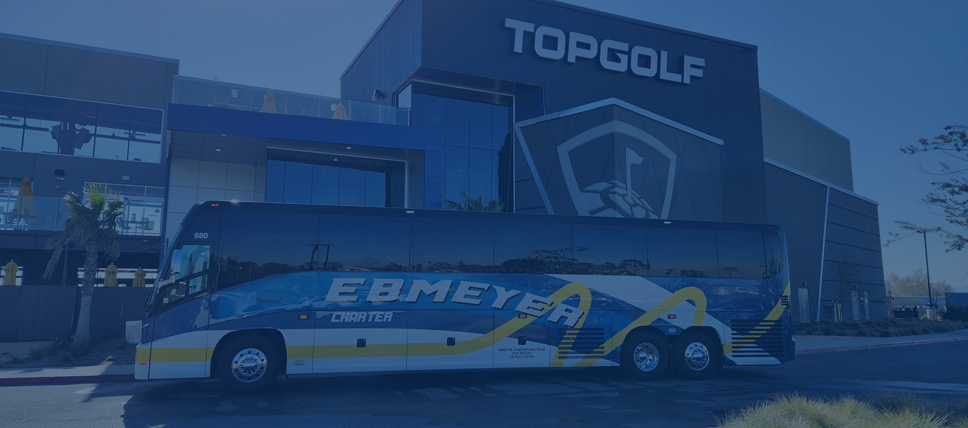 Charter bus outside Topgolf building